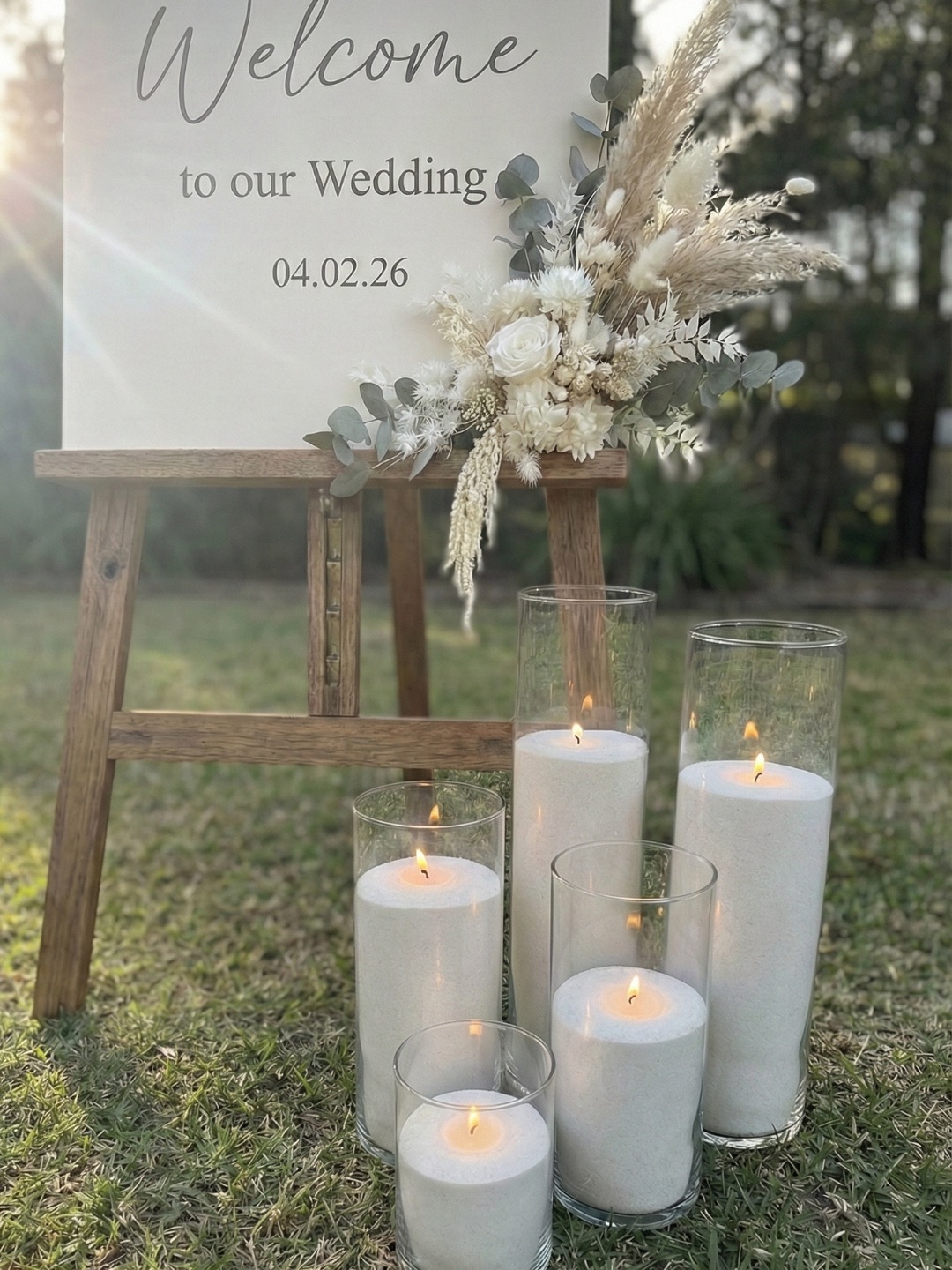 Glass candle vessels creating modern wedding ambience on a reception table