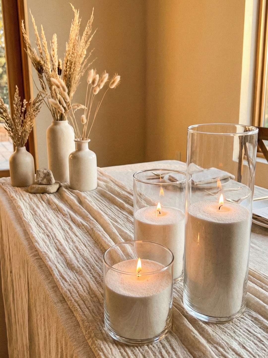 Wedding candles arranged neatly in glass vessels ready for collection and return